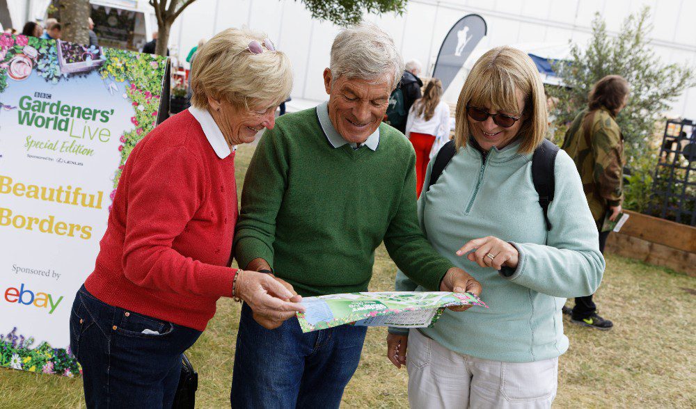 Visitors looking at the pocket map at BBC Gardeners' World Live