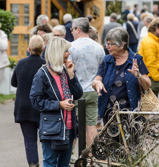 Two festivalgoers having a chat at BBC Gardeners' World Live