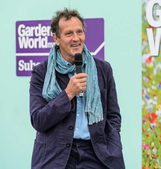 Monty Don presenting onstage with microphone at BBC Gardeners' World Live