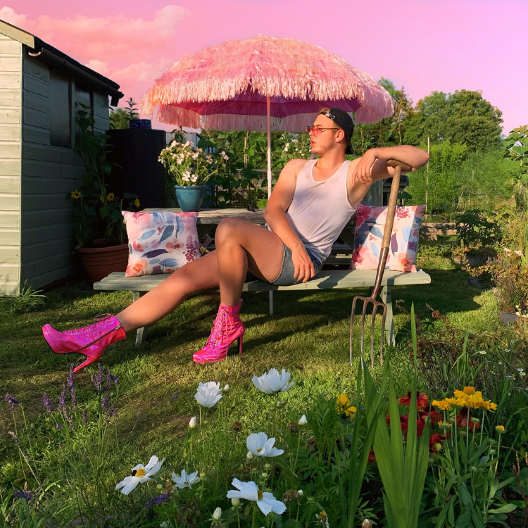 Untitled design – 2023-05-19T123441.428 Tom Leonard, the Drag Queen Gardener, reclining among flowers and plants